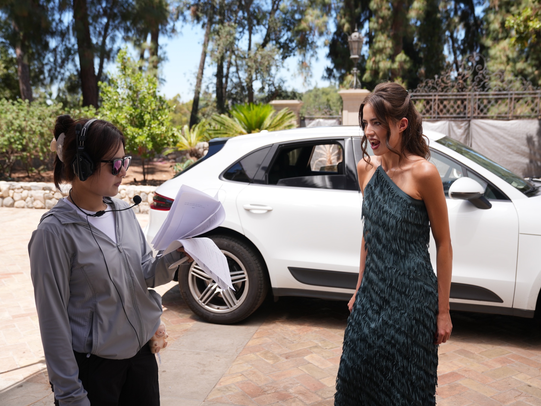 Vanessa von Schwarz on location in a fringe gown during a micro-drama shoot